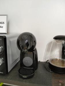 a coffee maker sitting on a counter next to a microwave at MARINA ROOMS in Alicante