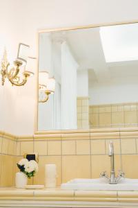 a bathroom with a sink and a mirror at La Famiglia in Pollena Trocchia