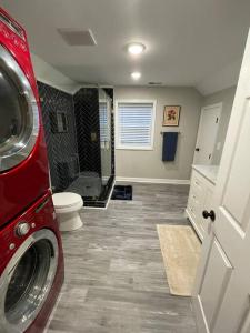 a bathroom with a toilet and a shower with a washing machine at Hilltop Haven w/Creek&Waterfall Dntwn McCaysville in McCaysville