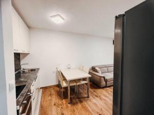 a small kitchen with a table and a couch at O3 Apartments in Tivat