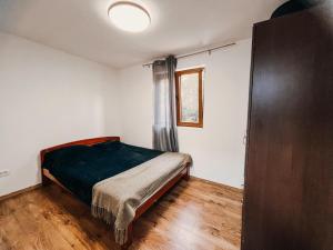 a small bedroom with a bed and a window at O3 Apartments in Tivat +33 photos