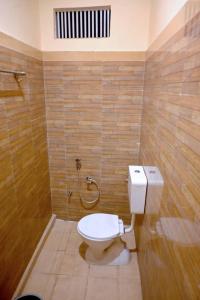 a bathroom with a toilet and a shower at Hotel Bhagwaan Das In Varanasi in Varanasi