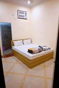 a small bed in a room with at Hotel Bhagwaan Das In Varanasi in Varanasi