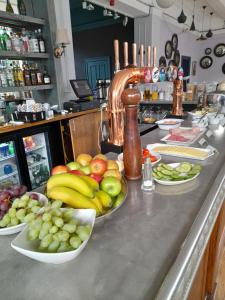 a counter top with plates of fruit on it at The Windmill Hotel in London