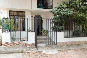 an entrance to a house with a black gate at Genesis Hospedaje Yopal in Yopal