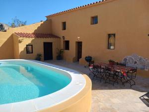 a patio with a swimming pool next to a house at Cortijo rural los Cerezos pueblo Taberno in Albox