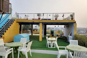 a patio with tables and chairs on a roof at Hotel Reshmi In Agra in Agra