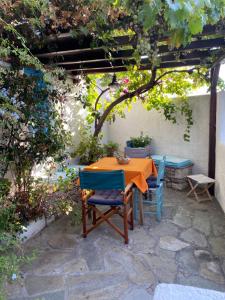 a table and chairs sitting under a pergola at Two sisters in Alonnisos Old Town