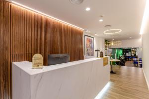a lobby with a wooden wall with a sign on it at 2M BOUTIQUE HOTEL in Montijo
