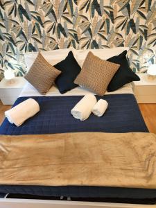 a large bed with two pillows on top of it at Roma Maison Gio' in Rome