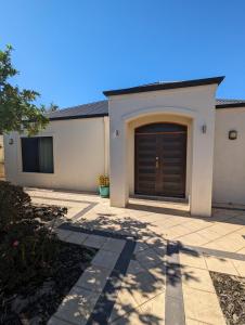 a garage with a brown door on a house at Lake Estate Stay in Perth