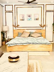 a bedroom with a bed with a ceiling fan at Nandi Private Residence, Bohemian Hill View Villa in Devanahalli-Bangalore