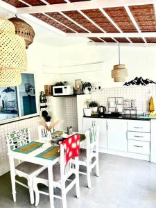 a kitchen with a table and chairs in a room at Nandi Private Residence, Bohemian Hill View Villa in Devanahalli-Bangalore