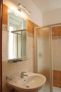 a bathroom with a sink and a shower and a mirror at Adorasuite B&B in Rome