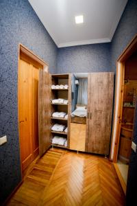a room with a wooden cabinet with shoes in it at Hotel Samta in Tskaltubo