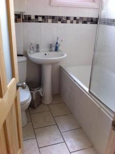 a bathroom with a sink and a toilet and a shower at London 2 Bed Flat Zone2 in London