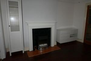 a living room with a fireplace and a door at London 2 Bed Flat Zone2 in London