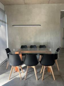 ein Esszimmer mit Glastisch und Stühlen in der Unterkunft Excepcional Casa en Solanas Resort in Punta del Este + 25 Fotos