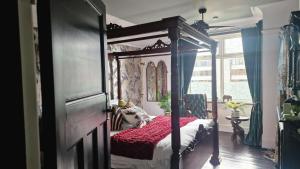 a bedroom with a canopy bed and a window at Flawsome Stays Unique Home w Quirky basement for 12 Guests by Harbour and Town in Ramsgate