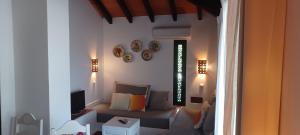 a living room with a couch and a tv at Cozy Beach House in Santa Luzia