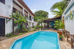 a swimming pool in front of a house at No Worries Pipa in Pipa