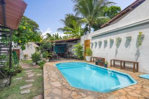 a swimming pool in the backyard of a house at No Worries Pipa in Pipa