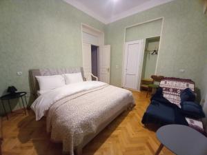 a bedroom with a bed and a table and a chair at Old Gate in Telavi