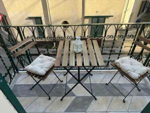 a table and two chairs on a balcony at Chez Thérèse in Sestri Levante