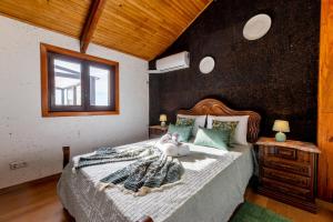 un dormitorio con una cama y una ventana en Casinha do Quadro, en Figueiró dos Vinhos 23 fotos más