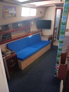 a bedroom with a blue bed and a tv at Dream Lady in Jewfish