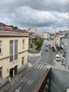 a view of a city street with cars on the road at My Home in Braga