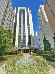 a large building with a fountain in front of it at Apart-hotel 1804 - Le Premier Suítes Jardim Paulista in Sao Paulo