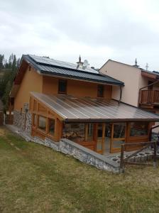 a house with solar panels on the roof at Bungalov Jozef in Liptovská Teplička