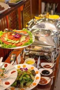 a buffet with plates of food on a table at Tam Coc Condelux Boutique Hotel & Travel in Ninh Binh