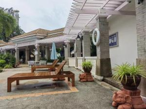 ジョムティエンビーチにある暂停-中天海滩的私人别墅の家の前に木製ベンチ2台付きのパティオ
