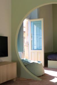 a room with a mirror and a bed in front of a door at Civita Boutique in Catania