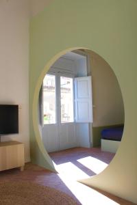 an archway in a room with a window and a television at Civita Boutique in Catania