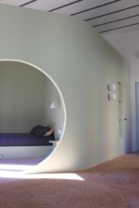 a bedroom with a bed in a round mirror at Civita Boutique in Catania