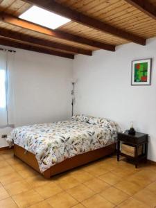 a bedroom with a bed and a night table at Finca Marañuela in La Perdoma