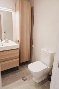 a bathroom with a white toilet and a sink at Biasa Holidays in Torrox Costa