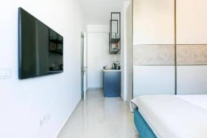 a bedroom with a bed and a flat screen tv at Luxury Suite 3 in Himara in Himare
