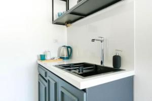 a kitchen with blue cabinets and a sink at Luxury Suite 3 in Himara in Himare