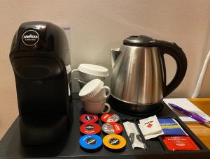 a counter with a coffee maker and a tea kettle at Casale Delle Ronde B&B in Latina