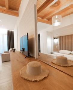 two hats sitting on the floor of a living room at Don Mare in Dhërmi