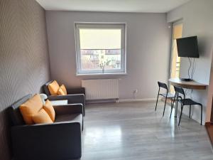 a living room with a couch and chairs and a window at Witkowska-nocleg in Wrocław