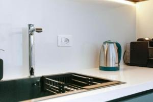 a kitchen counter with a sink and a toaster at Luxury Suite 2 in Himara in Himare