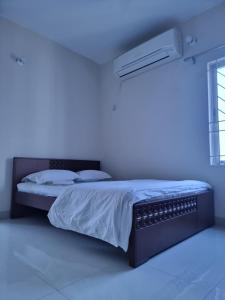 a bed in a white room with a blue light at Cozy Stay in New Flat, Dhaka, BD in Dhaka