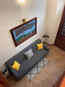 a living room with a blue couch with yellow pillows at Old San Juan Historic Loft 4 The Adventurous in San Juan