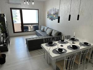 a living room with a table and a couch at LT Apartment in Vratsa