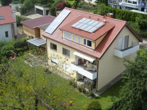 an image of a house with solar panels on the roof at BodenSEE Apartments Daisendorf nahe Meersburg in Daisendorf